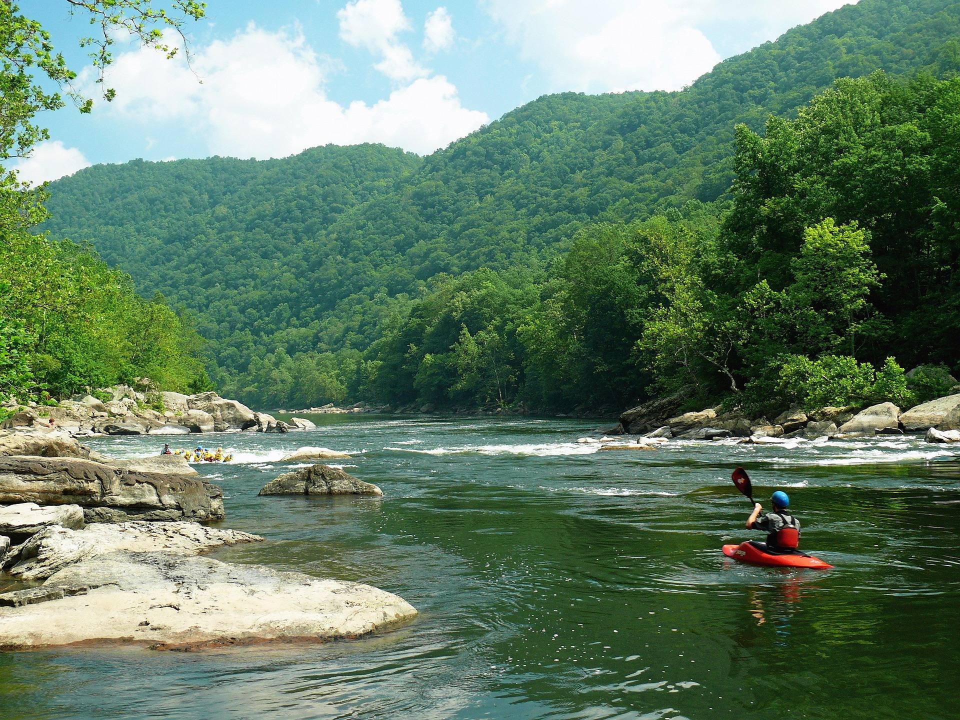 Kayaker paddling through rapids on the New River in New River Gorge National Park, West Virginia